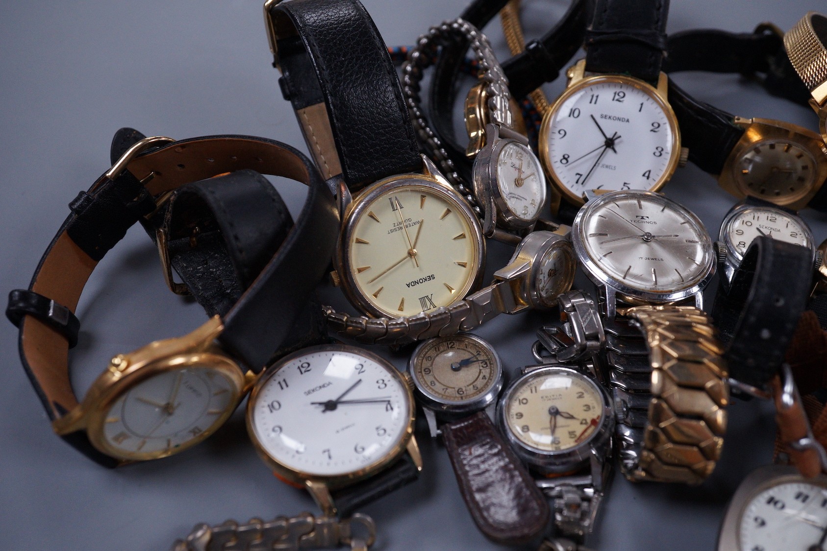 Seven assorted gentleman's wrist watches including steel Ingersoll and steel Technics, Adano and Sekonda and twelve assorted lady's wrist watches including Timex, Editia and a yellow metal Winegartens.